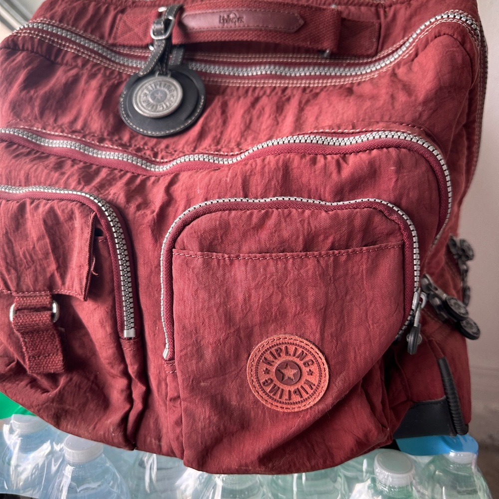 Kipling carry on Burgundy Backpack with Multiple Pockets